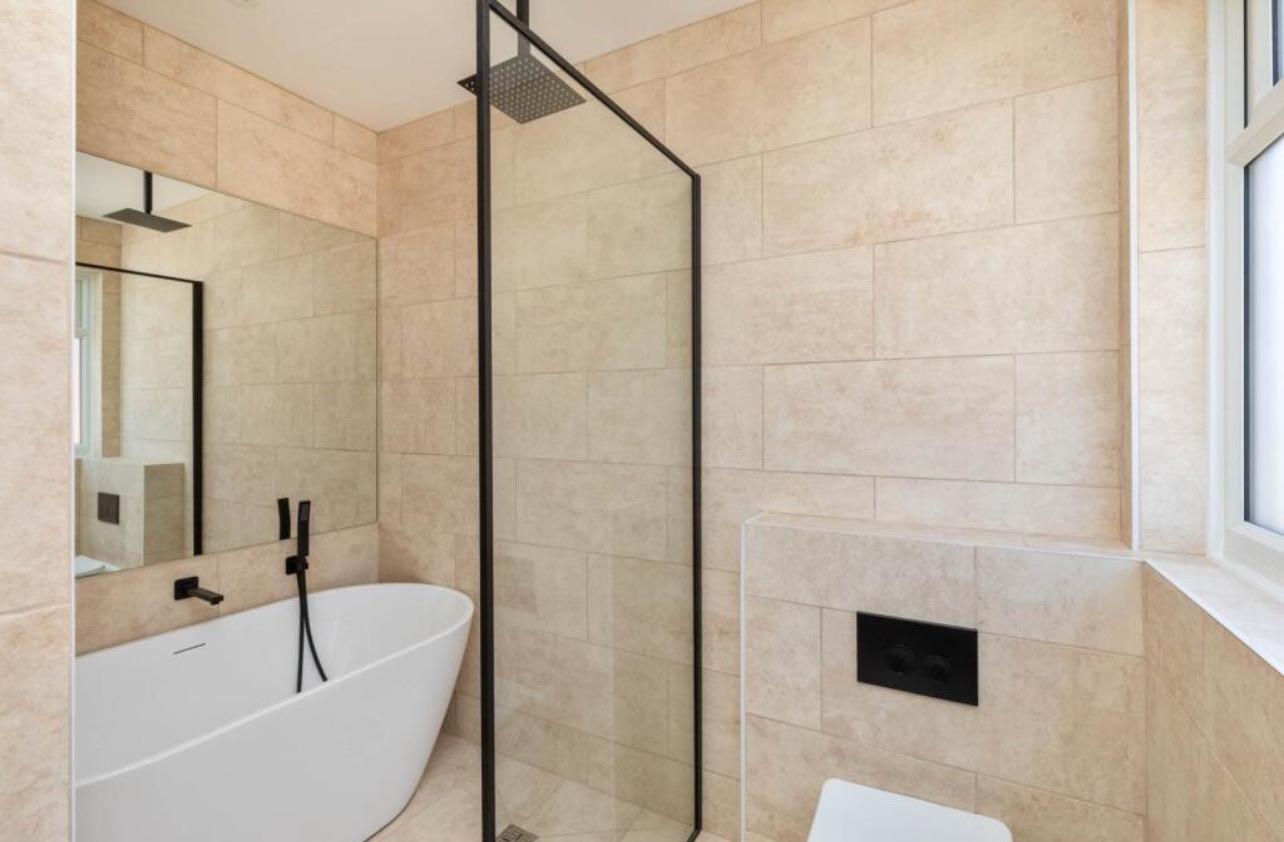 Finished bathroom with a freestanding bath and walk-in shower